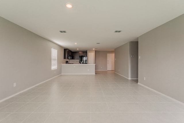 unfurnished living room with recessed lighting, baseboards, and visible vents