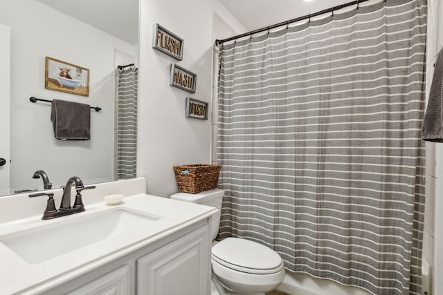 bathroom featuring toilet and vanity