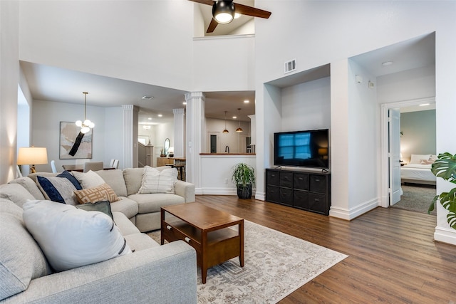 9816 Hedge Bell Dr, Mckinney, TX 75072 - living area featuring ceiling fan, decorative columns, dark wood-style flooring, visible vents, and baseboards