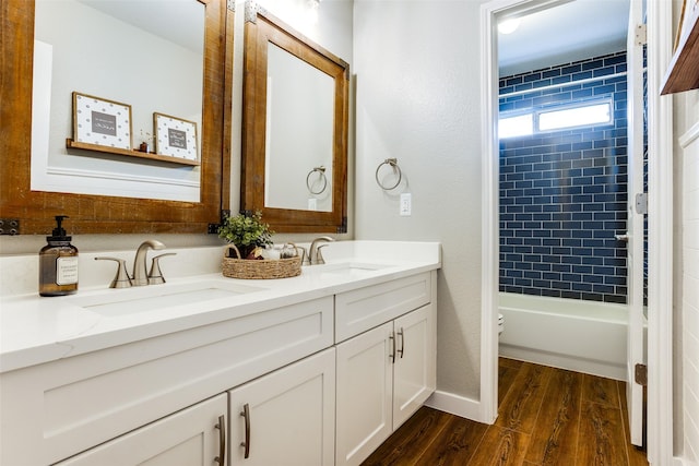 9816 Hedge Bell Dr, Mckinney, TX 75072 - bathroom with double vanity, a sink, wood finished floors, and toilet