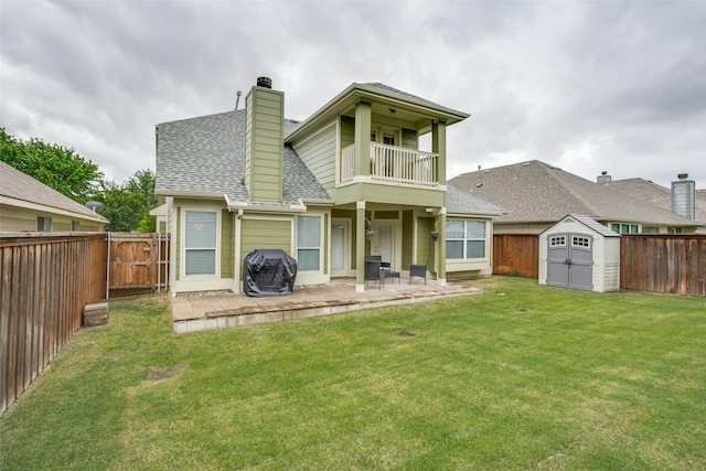 9816 Hedge Bell Dr, Mckinney, TX 75072 - back of property with a storage shed, a fenced backyard, a balcony, and roof with shingles