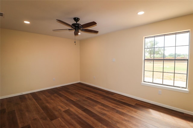spare room with a ceiling fan, recessed lighting, visible vents, baseboards, and dark wood-style floors