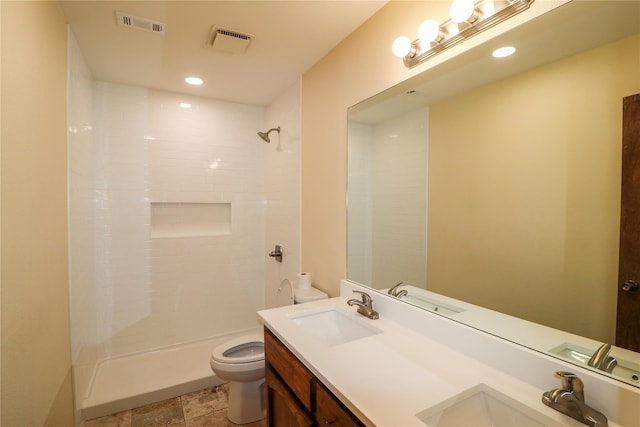 full bathroom with a sink, toilet, and visible vents