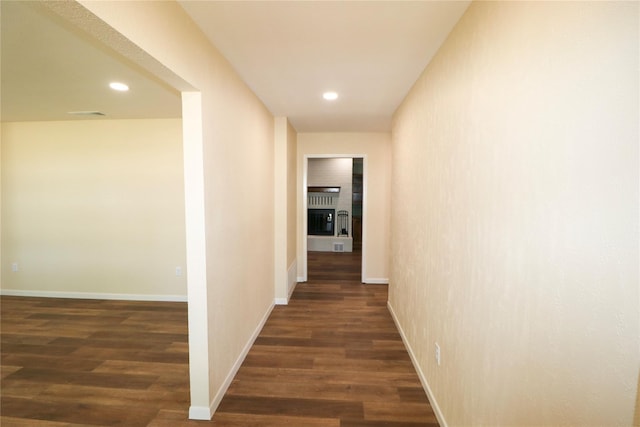 hallway with recessed lighting, baseboards, and dark wood finished floors