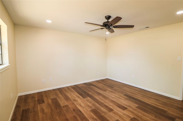 empty room with visible vents, a ceiling fan, dark wood-type flooring, and recessed lighting