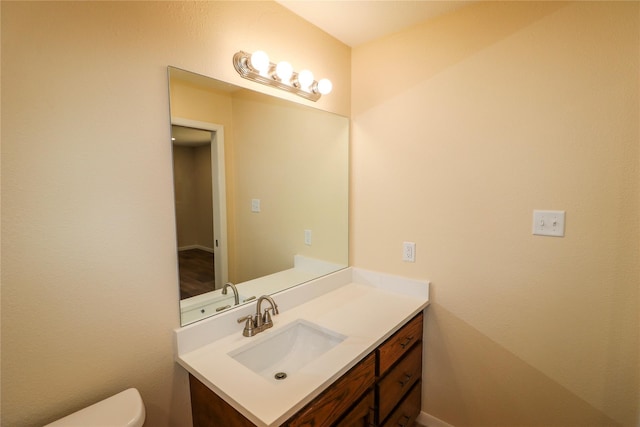 bathroom featuring toilet and vanity