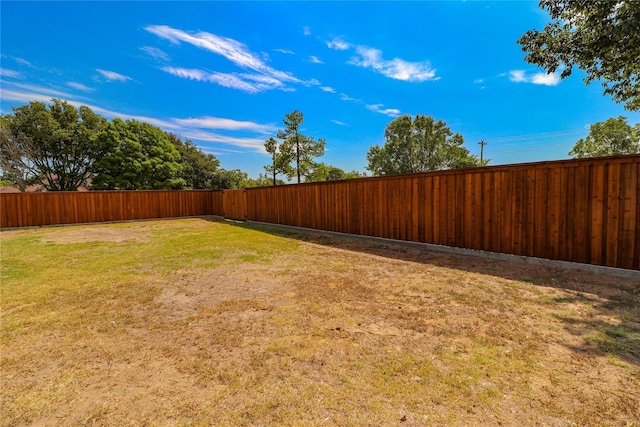 view of yard with a fenced backyard
