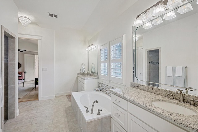 full bathroom with a sink, two vanities, visible vents, tiled shower, and a bath