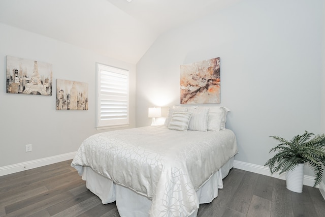 bedroom with dark wood-type flooring, baseboards, and vaulted ceiling