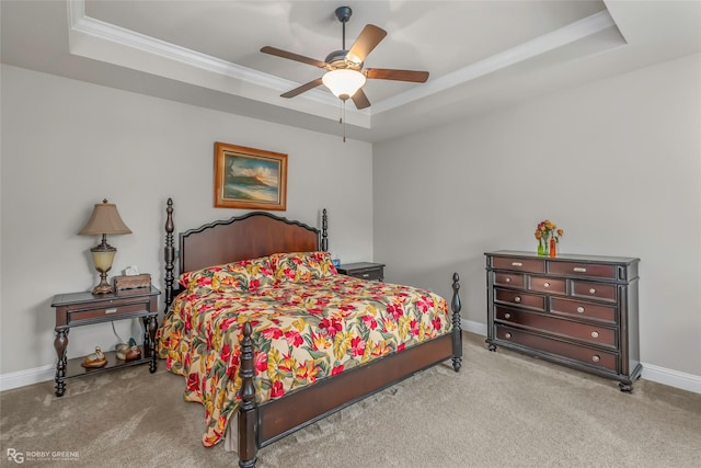 bedroom with baseboards, carpet flooring, a raised ceiling, and ornamental molding
