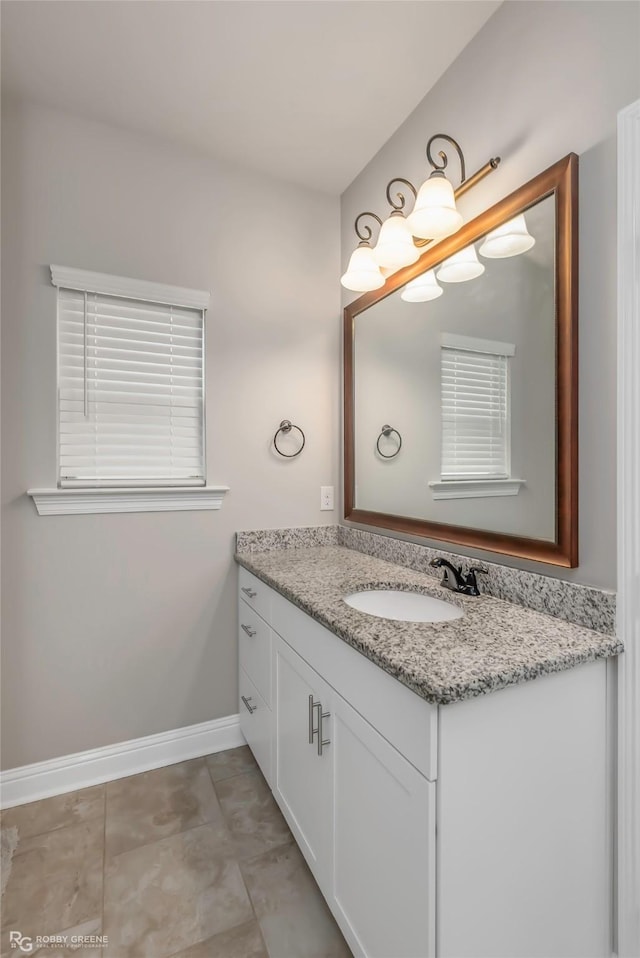 bathroom featuring baseboards and vanity