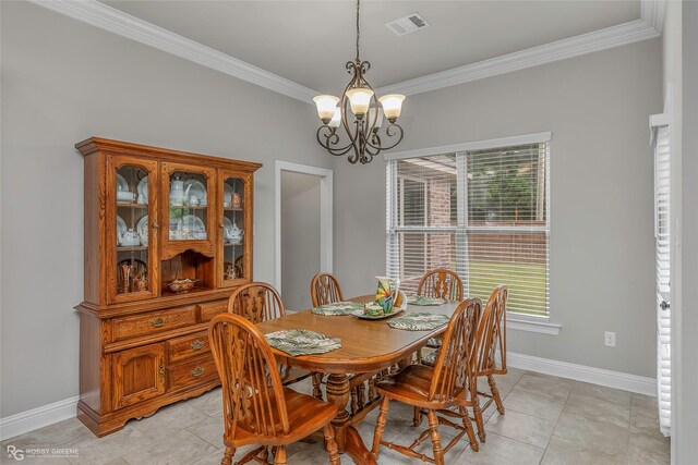 dining room featuring crown molding, baseboards, visible vents, and a chandelier