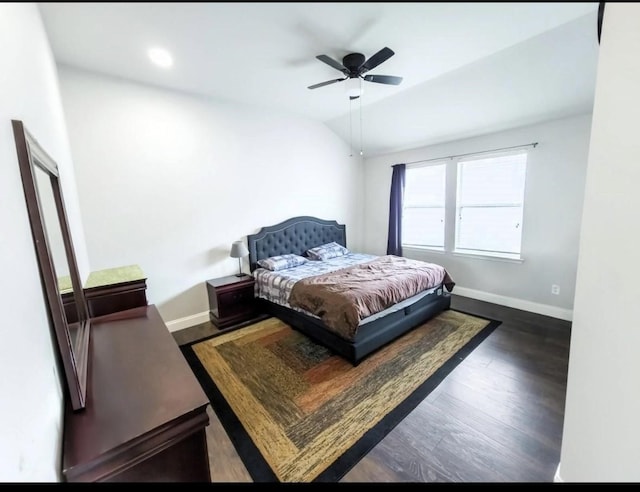 bedroom featuring baseboards, ceiling fan, wood finished floors, and lofted ceiling
