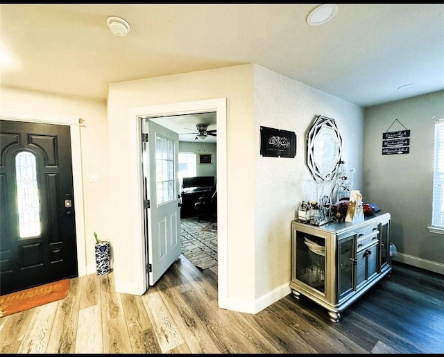 entrance foyer featuring baseboards, ceiling fan, and wood finished floors