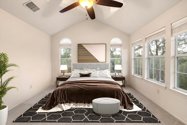 carpeted bedroom with vaulted ceiling with beams, multiple windows, baseboards, and visible vents