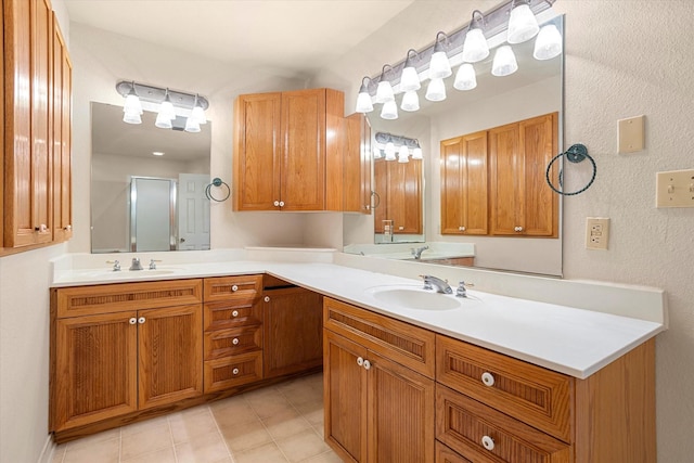 bathroom featuring a sink, an enclosed shower, and double vanity