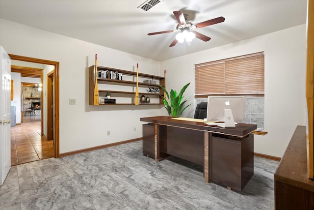 office featuring visible vents, a ceiling fan, and baseboards