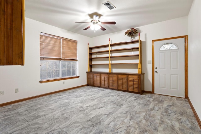 interior space with plenty of natural light, baseboards, ceiling fan, and visible vents
