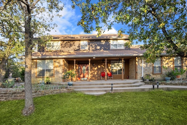 back of property featuring a yard, a patio, ceiling fan, and stone siding