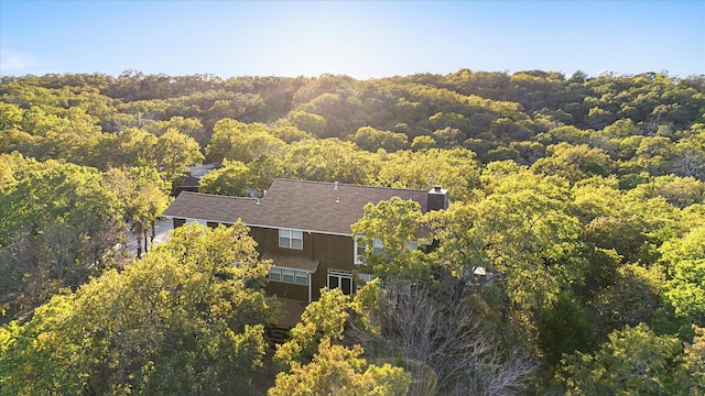 drone / aerial view featuring a view of trees