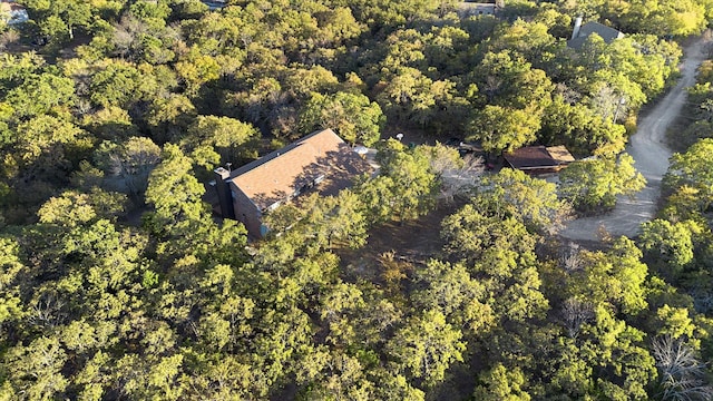 drone / aerial view featuring a wooded view
