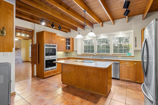 kitchen featuring a kitchen island, wood ceiling, a sink, light tile patterned floors, and stainless steel appliances