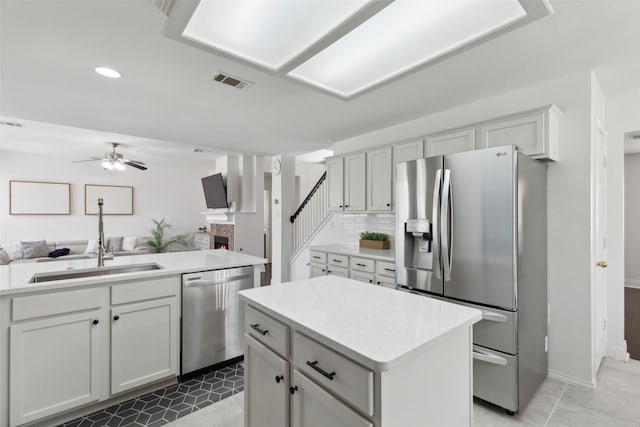 1406 Springmeadow Dr, Allen, TX 75002 - kitchen with stainless steel appliances, open floor plan, a ceiling fan, a kitchen island, and recessed lighting