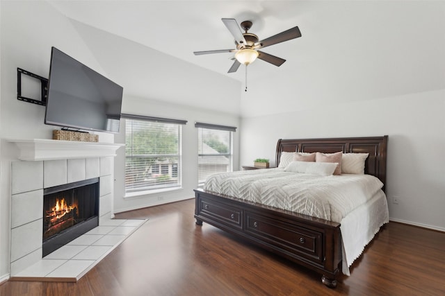 1406 Springmeadow Dr, Allen, TX 75002 - bedroom featuring wood finished floors, vaulted ceiling, a tile fireplace, ceiling fan, and baseboards