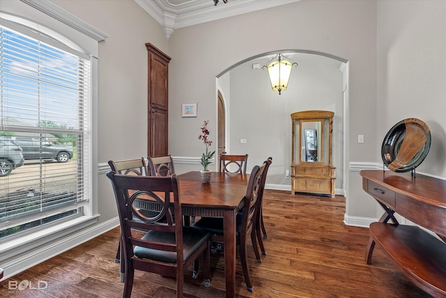 221 Cattail Trl, Benton, LA 71006 - dining space featuring crown molding, arched walkways, and wood finished floors
