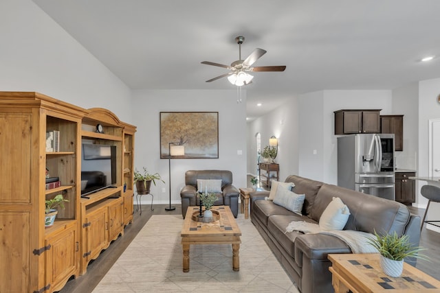 living area with recessed lighting, ceiling fan, baseboards, and light wood-type flooring