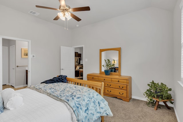 bedroom featuring ceiling fan, visible vents, light colored carpet, baseboards, and lofted ceiling