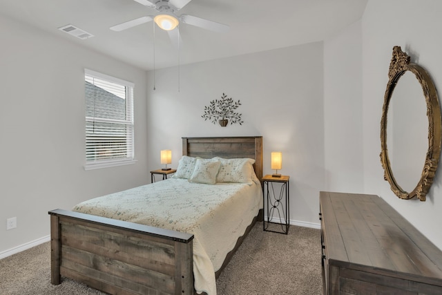 carpeted bedroom with visible vents, baseboards, and ceiling fan
