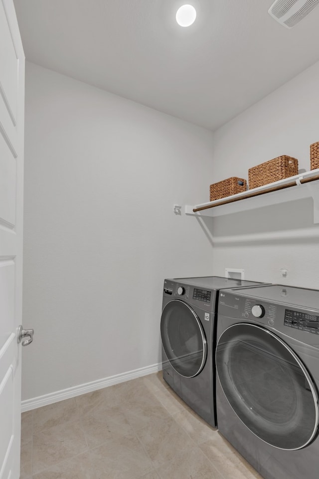 laundry room featuring baseboards, laundry area, washer and clothes dryer, and visible vents