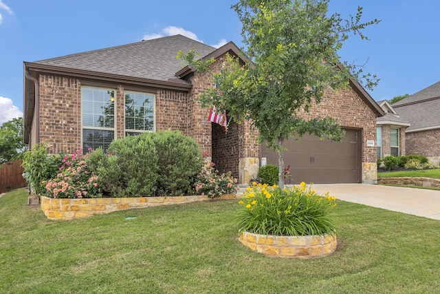 traditional-style home featuring a shingled roof, concrete driveway, a front yard, and brick siding