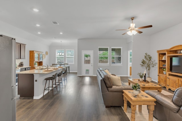 living area with ceiling fan, visible vents, baseboards, recessed lighting, and dark wood-type flooring