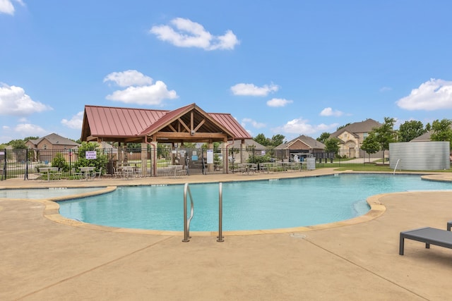 pool featuring fence and a patio