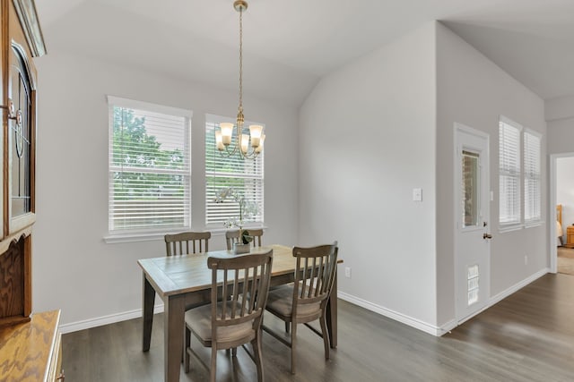 dining room with baseboards, wood finished floors, a chandelier, and vaulted ceiling
