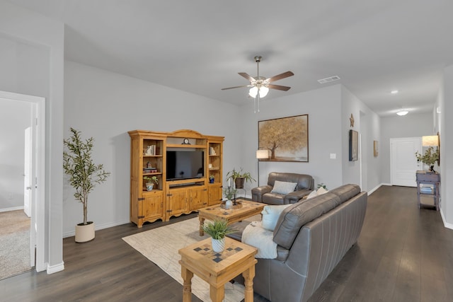 living area featuring baseboards, dark wood finished floors, ceiling fan, and visible vents