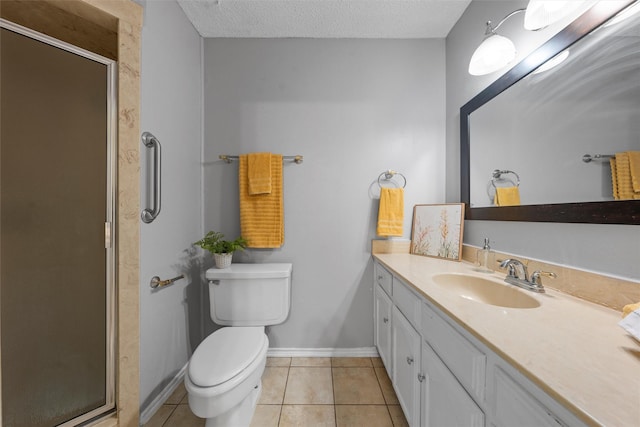 full bathroom featuring tile patterned flooring, vanity, toilet, baseboards, and a stall shower