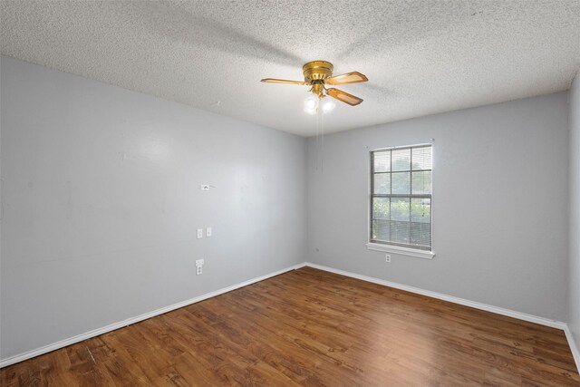unfurnished room featuring baseboards, a textured ceiling, ceiling fan, and wood finished floors
