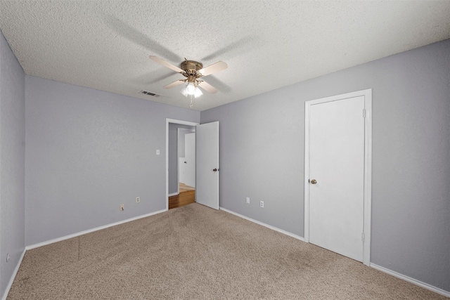 unfurnished bedroom with carpet floors, ceiling fan, baseboards, and visible vents