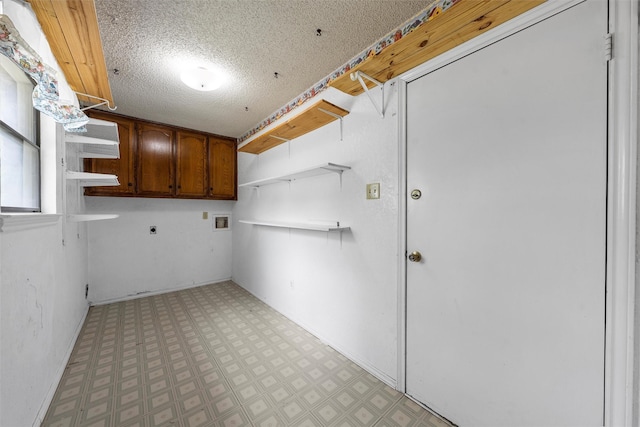 laundry room with light floors, hookup for a washing machine, electric dryer hookup, and cabinet space