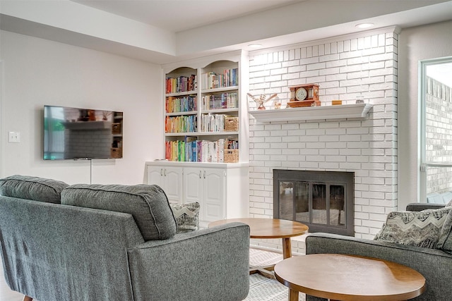 living room with built in features and a fireplace