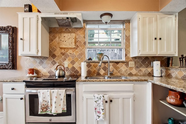 2704 Game Lake Dr, Irving, TX 75060 - kitchen with a sink, stainless steel range with electric stovetop, decorative backsplash, and white cabinetry
