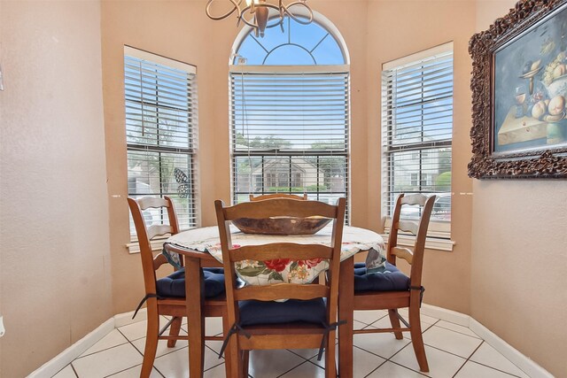 2704 Game Lake Dr, Irving, TX 75060 - dining space featuring light tile patterned flooring, baseboards, a notable chandelier, and plenty of natural light