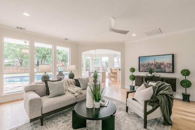 300 Preakness Cir, Southlake, TX 76092 - living area featuring arched walkways, plenty of natural light, ornamental molding, light wood-style floors, and a ceiling fan
