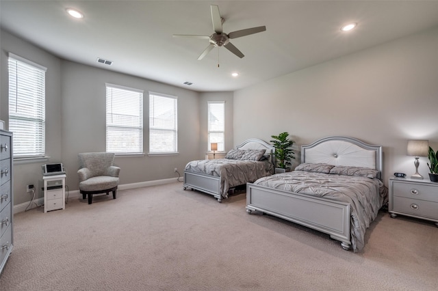 bedroom featuring recessed lighting, baseboards, light carpet, and multiple windows