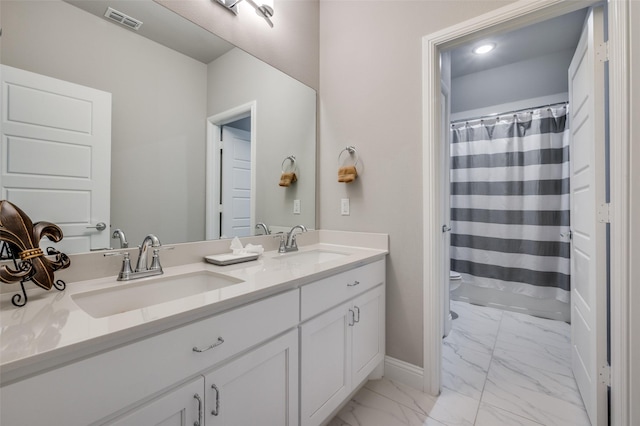 bathroom with a sink, visible vents, double vanity, and marble finish floor