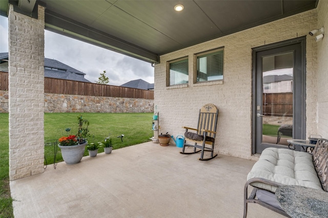 view of patio featuring fence