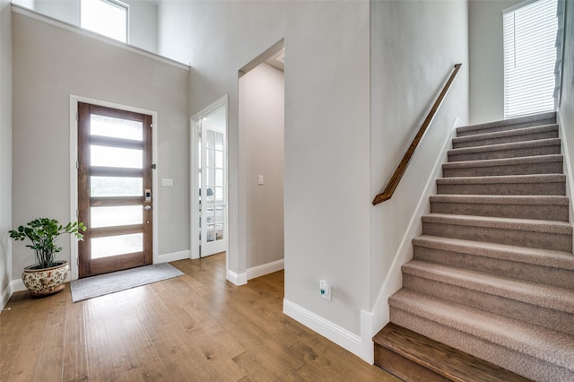 9767 Maple Hill Ln, Frisco, TX 75035 - entrance foyer with wood finished floors, stairs, and baseboards
